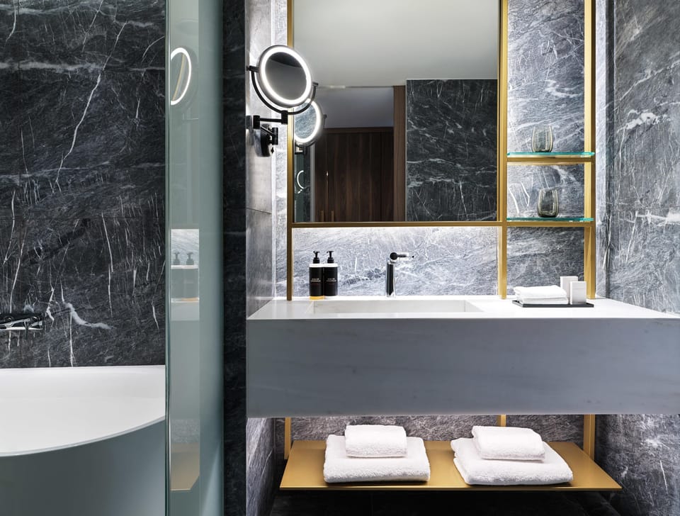 Corner Suite with 1 King Bed | Bathroom | Designer toiletries, hair dryer, bathrobes, slippers