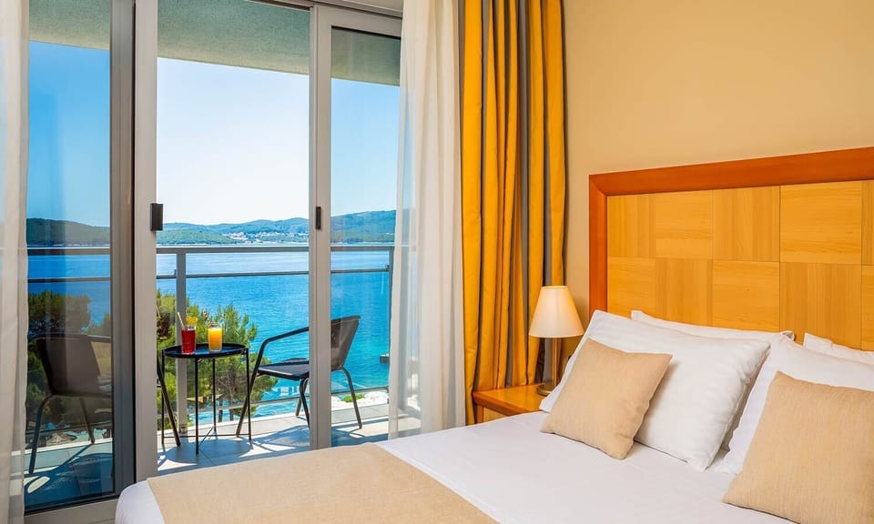 Family room with seaside balcony | Minibar, in-room safe, desk, blackout drapes