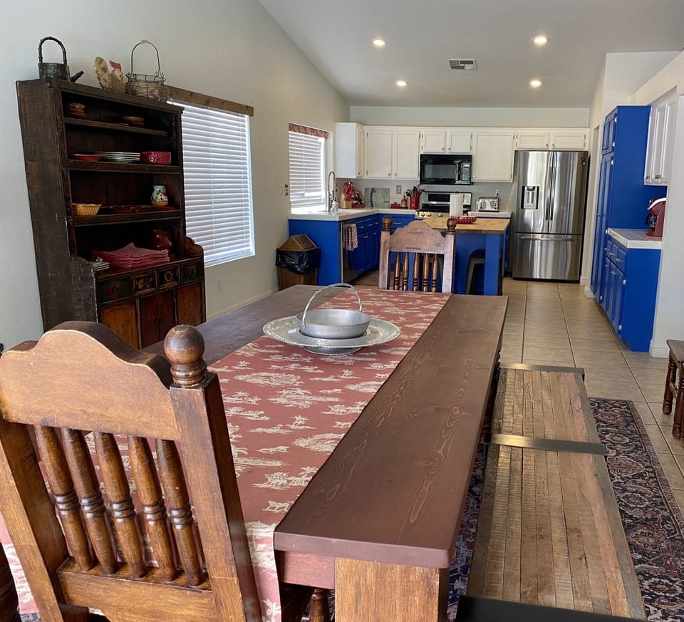 Large dining table for 10 people, with barn doors to the family room. 