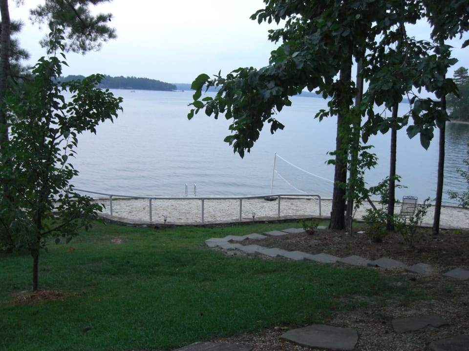 Facing the volley ball court overlooking the water. 