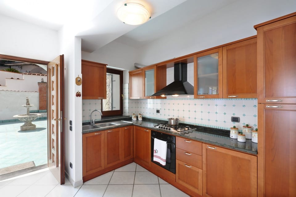 Apartment | Private kitchen | Full-size fridge, stovetop, electric kettle, cookware/dishes/utensils