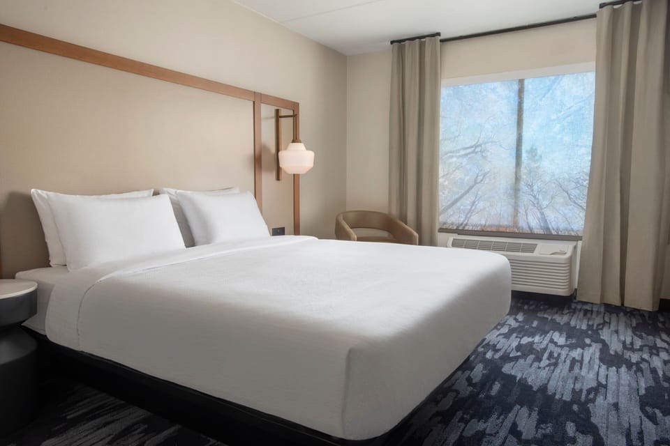 Premium bedding, desk, laptop workspace, blackout drapes