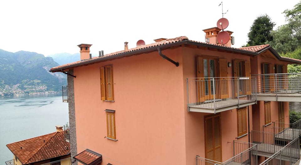 View of rear of property with lake behind