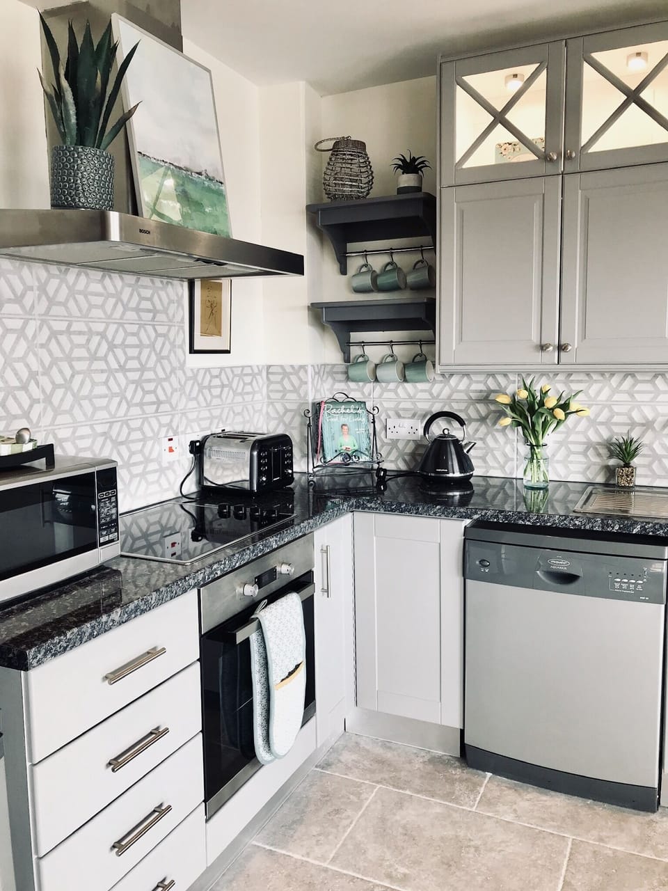 The kitchen is equipped with a hob, oven, microwave, dishwasher and washer/dryer