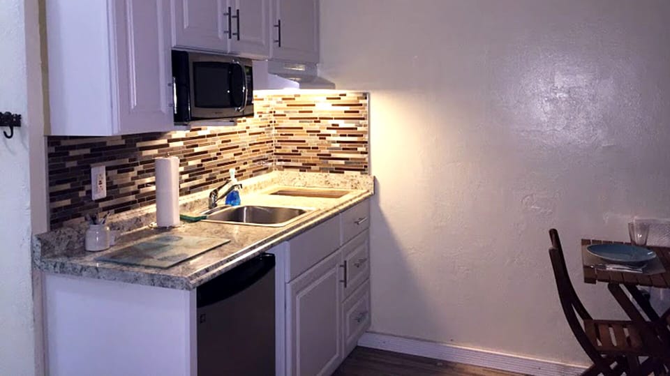 Kitchen is fully stocked with dishes, glassware and utensils