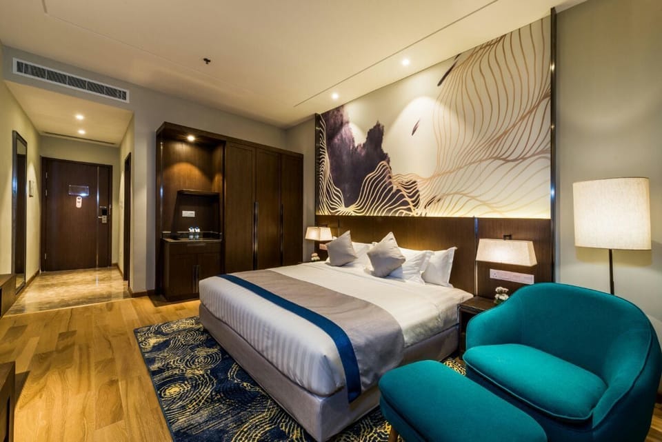 Deluxe Room, 1 Bedroom | Minibar, in-room safe, iron/ironing board, free WiFi