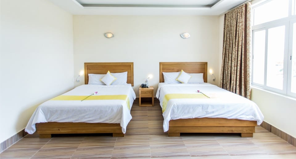 Deluxe Quadruple Room | Minibar, desk, WiFi (free), bed sheets