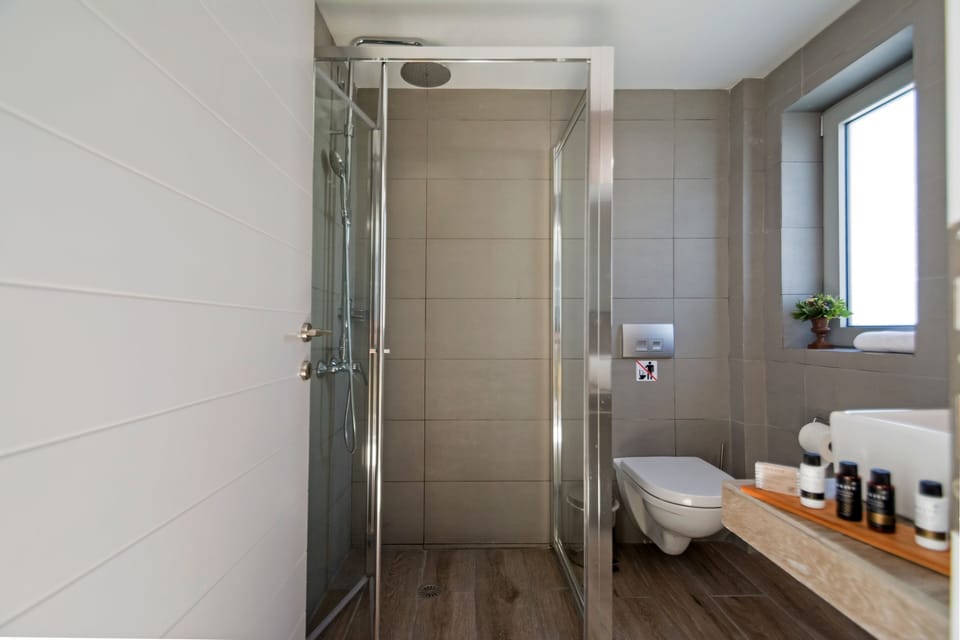 Shower, designer toiletries, hair dryer, towels