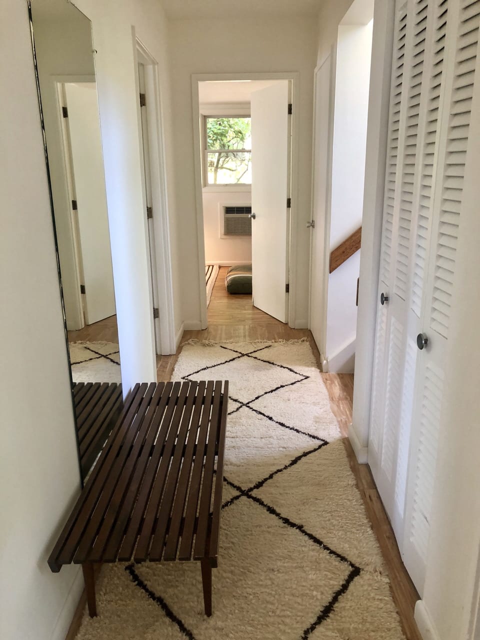Hallway leading to all bedrooms bathrooms and outside shower and water 