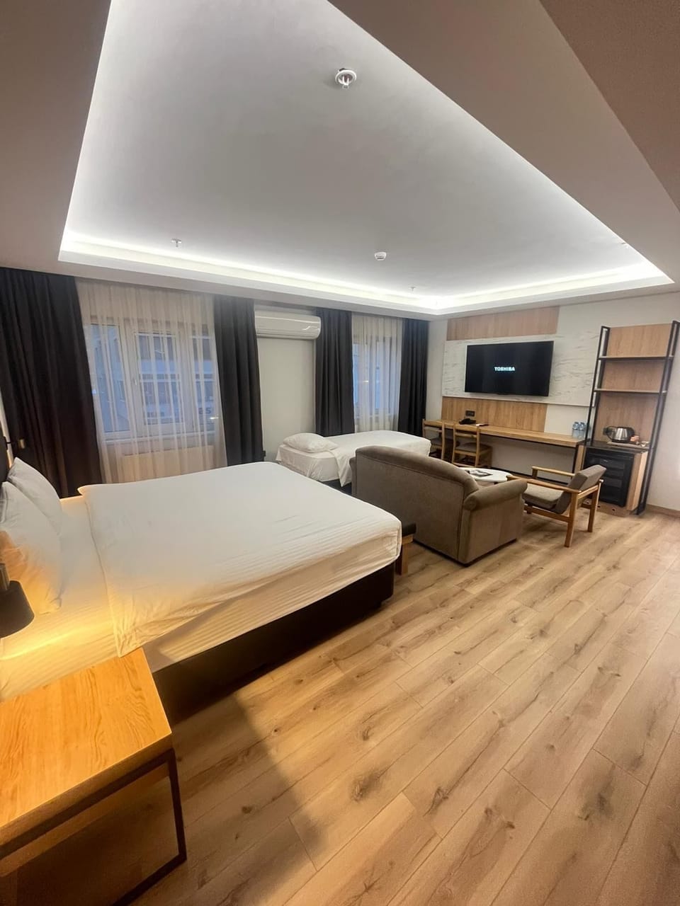 Comfort Quadruple Room | Living area | 45-inch LCD TV with satellite channels, TV