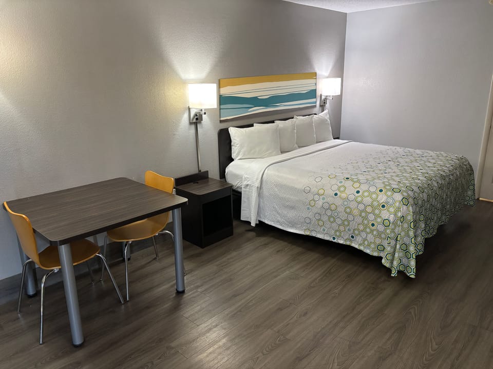 Premium bedding, desk, laptop workspace, blackout drapes