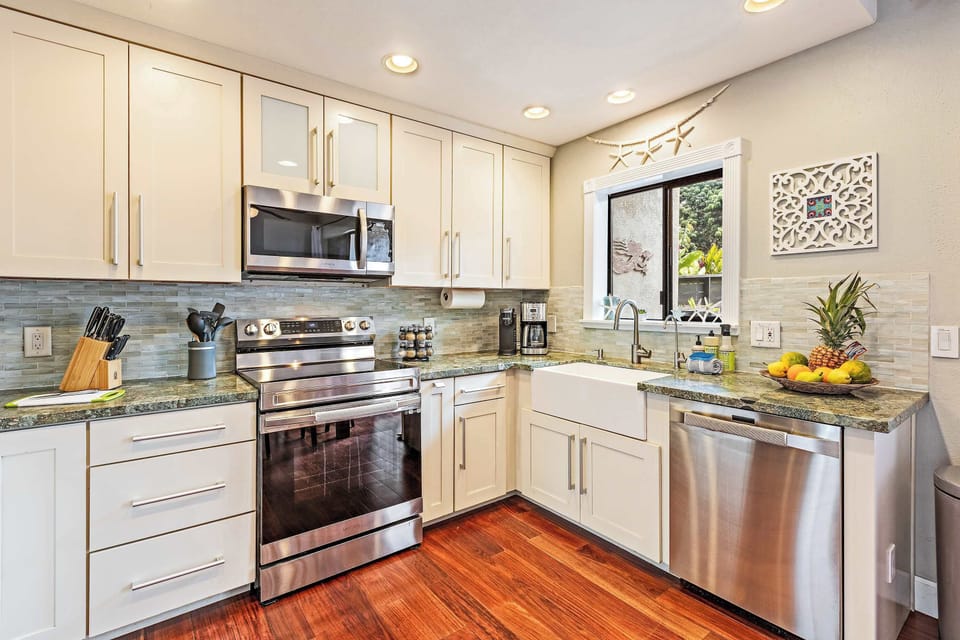 Enjoy cooking in this bright Maui kitchen, fully equipped with stainless steel appliances, granite counters, and farmhouse sink. Perfect for preparing family meals, saving money, and savoring island flavors in the comfort of your vacation retreat.