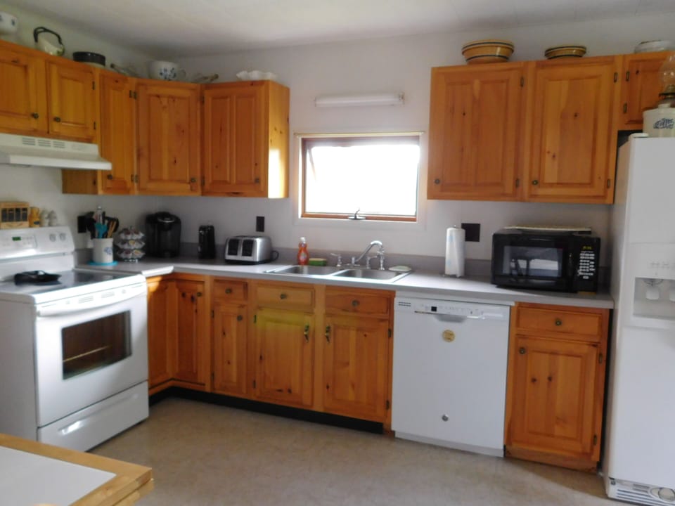 Kitchen supplied with Keurig, Mr Coffee, microwave, dishwasher and more