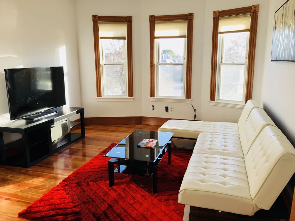 Relax at the spacious living room with sofa-beds, 54’ Plazma TV, and fire place