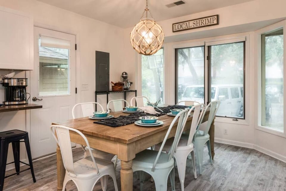 Restoration Hardware table with seating for 8 plus additional seating on bar (3) and coffee bar (2)
