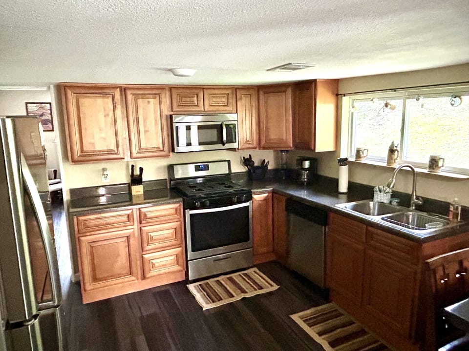 wood cabinet kitchen with new appliances, gas stove, microvawe