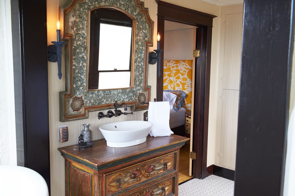Lower level bathroom with clawfoot tub, full size shower and linens.