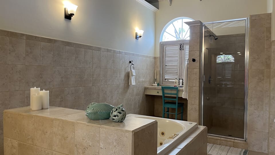Shower for two and a makeup area with seating in master bath
