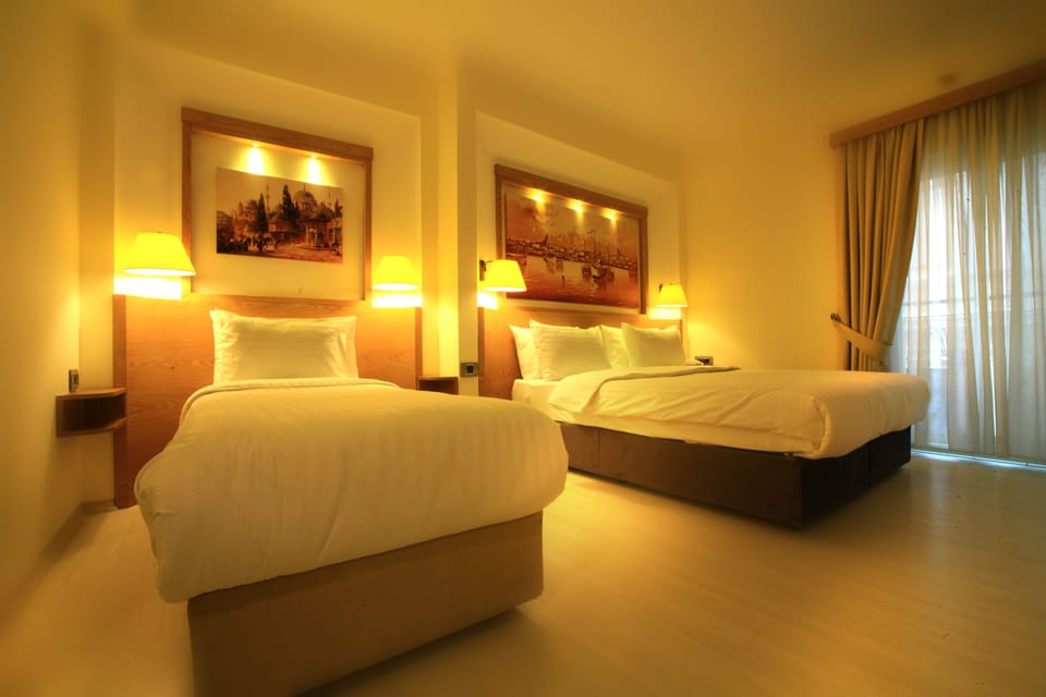 Superior Triple Room, Corner | Minibar, in-room safe, desk, laptop workspace