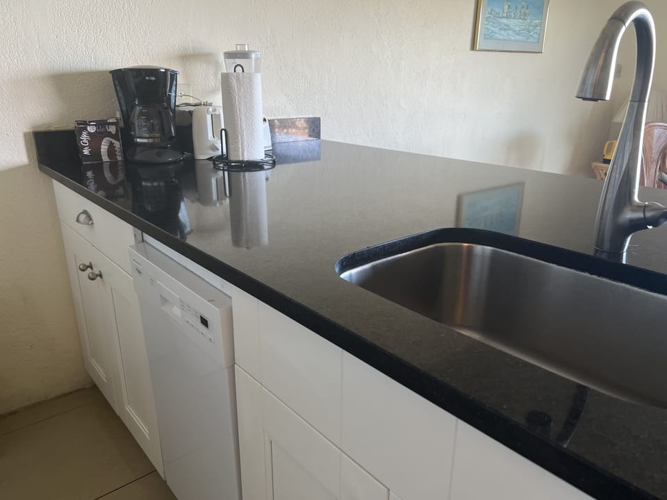 Beautiful quartz slab breakfast table with dishwasher
