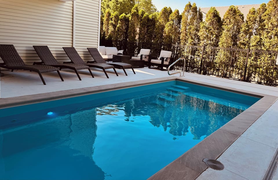 Gorgeous private heated pool area with pool loungers and outdoor sofa and chairs