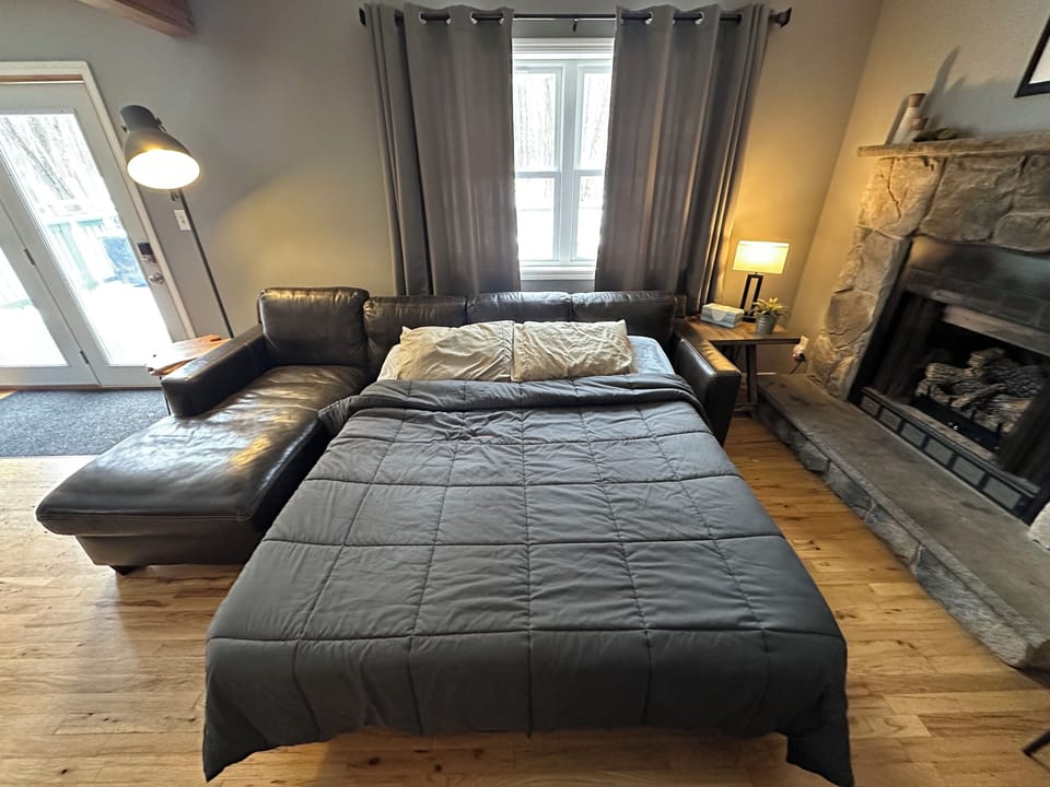 Full size sleeper sofa.  Comforter and pillows stored in daybed drawer in loft