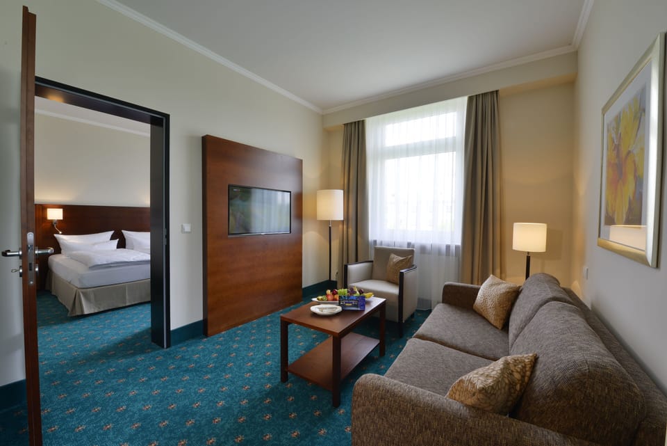 Junior Suite | Living area | 41-inch flat-screen TV with cable channels, TV, tablet