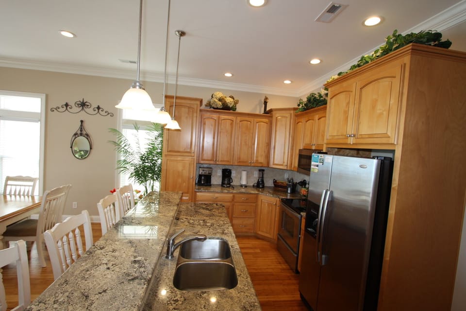 Stainless appliances and bar counter in kitchen 