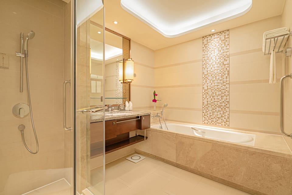 Separate tub and shower, designer toiletries, hair dryer, slippers