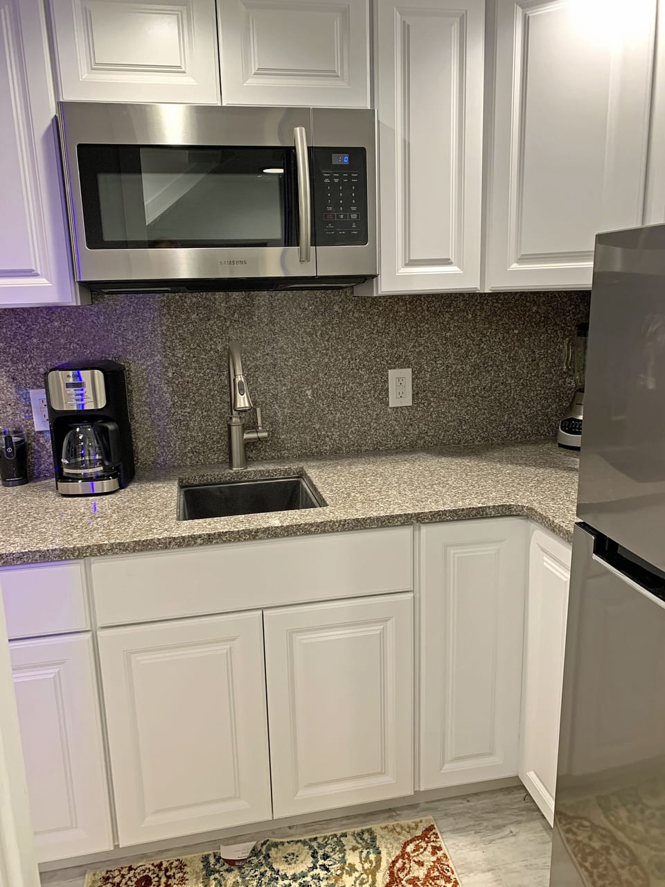 KITCHEN: Granite counters undermount sink. Built-in microwave and refrigerator.