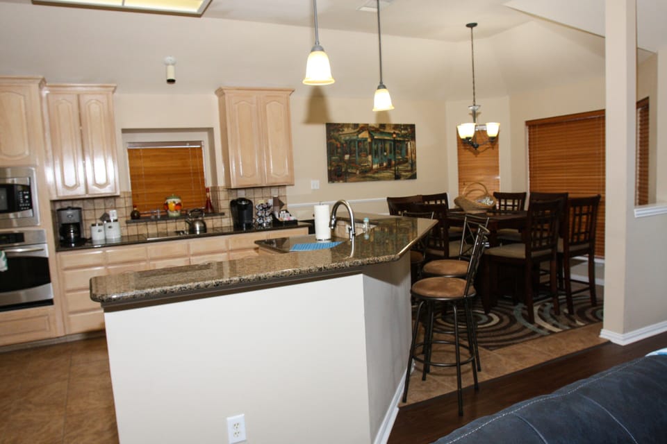 Kitchen and dining area open to family room