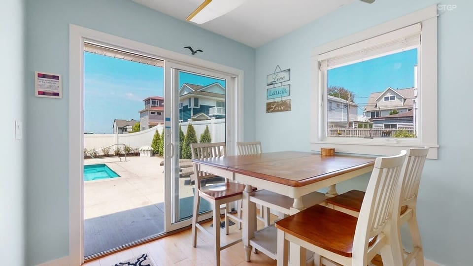 Breakfast nook with table and island seating with great view of pool and lake!