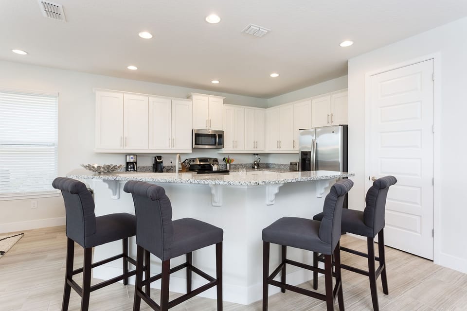 The kids can watch as you make pancakes in the morning in this kitchen complete with upgraded stainless steel appliances