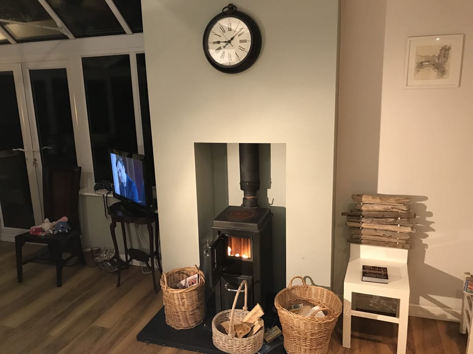 Working wood burner in the kitchen opening to  dining area