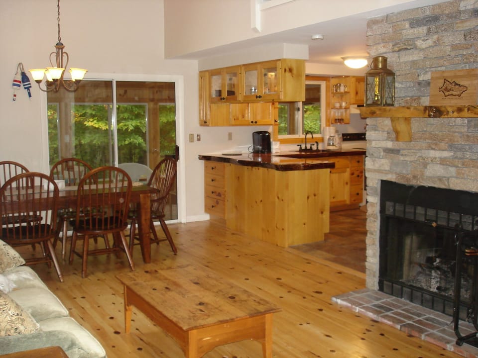 downstairs view to kitchen with fireplace