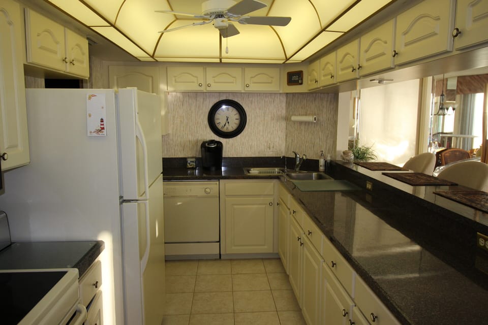 Great lighting in a fully equipped kitchen & walk-in pantry makes cooking easy.