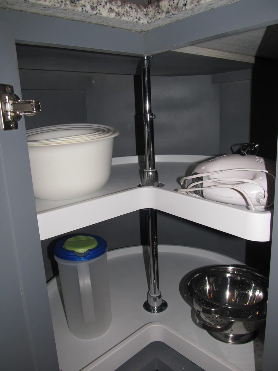 Corner cabinet with more kitchen items.