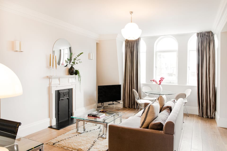 Premium Apartment, 1 King Bed | Living area | 42-inch flat-screen TV with satellite channels, TV, fireplace