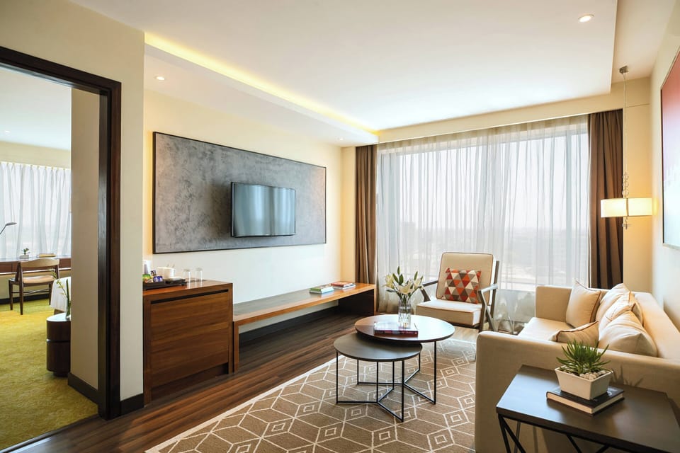 Executive Suite, 1 King Bed | Living area | 40-inch LED TV with cable channels, TV, pay movies