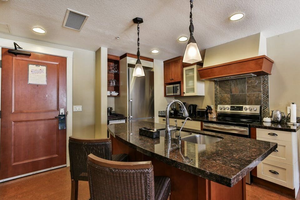 The gourmet, eat-in kitchen is fully stocked and features stainless steel appliances.