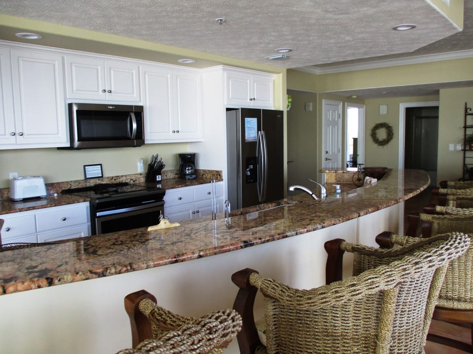 Kitchen features granite counter tops and new stainless steel appliances