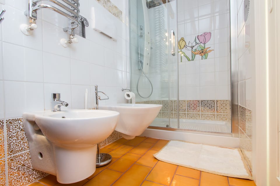 Single Room, 1 Large Twin Bed | Bathroom | Shower, rainfall showerhead, slippers, bidet
