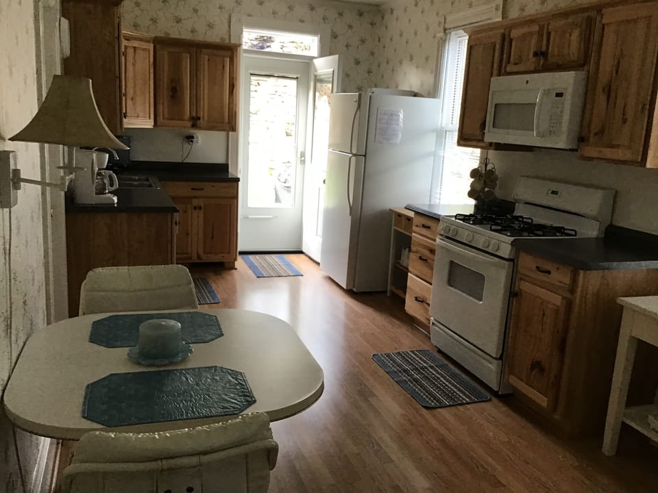 New hickory cabinets and door to outside deck with waterfalls