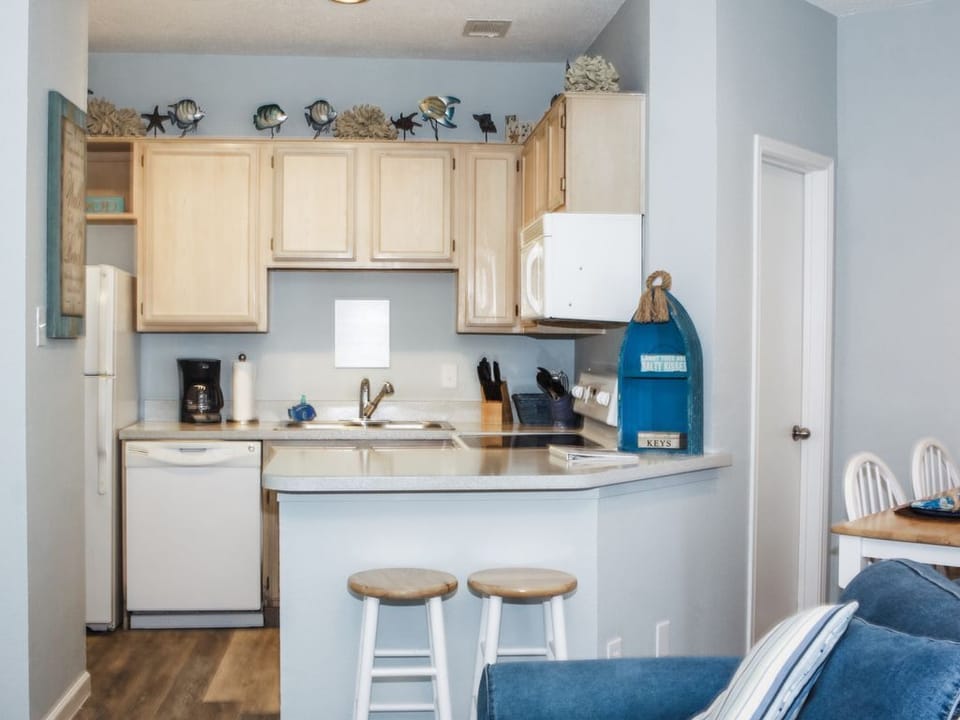 Fully equipped kitchen with plenty of room. Two bar stools, plus dining table.