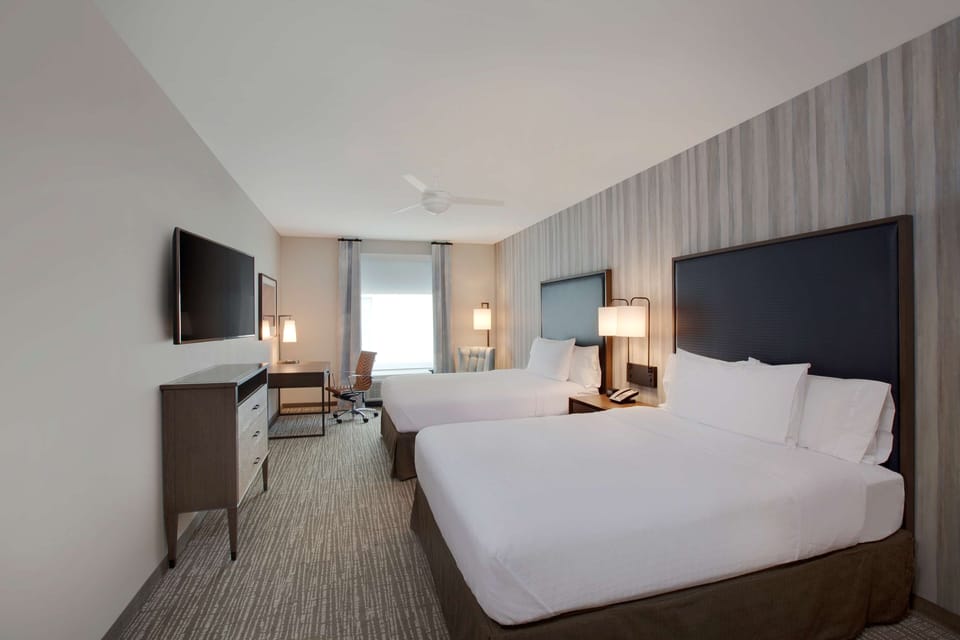 Premium bedding, desk, laptop workspace, blackout drapes