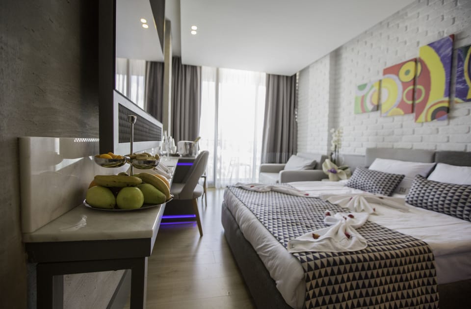 Deluxe Room, Balcony | Minibar, in-room safe, desk, laptop workspace