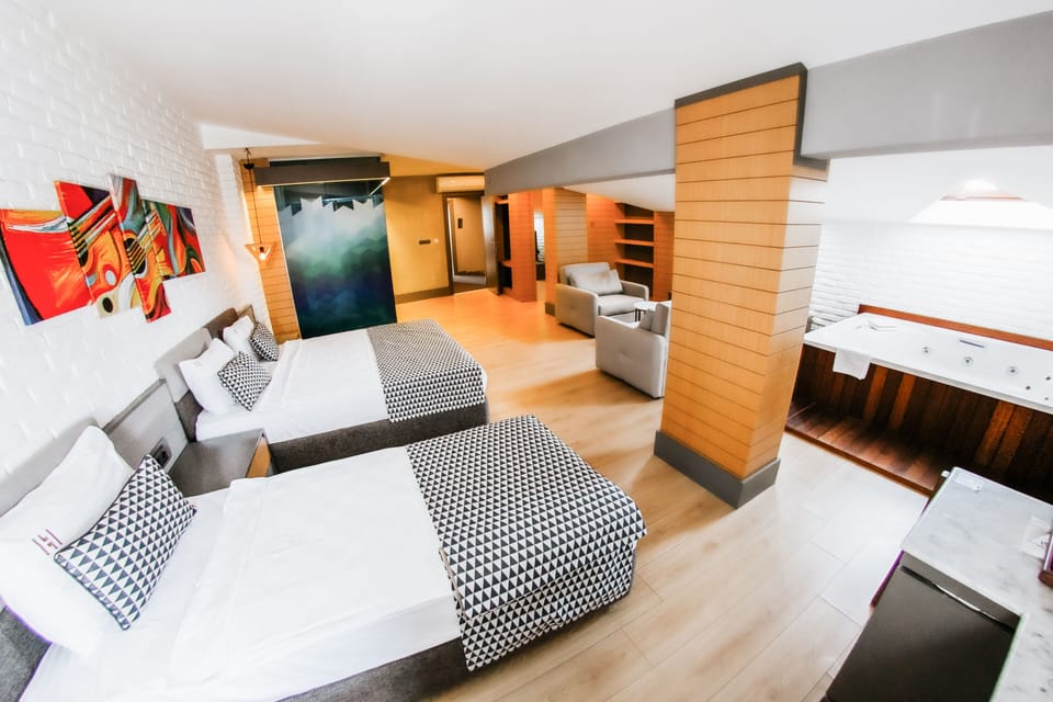 Suite, Garden View | Minibar, in-room safe, desk, laptop workspace