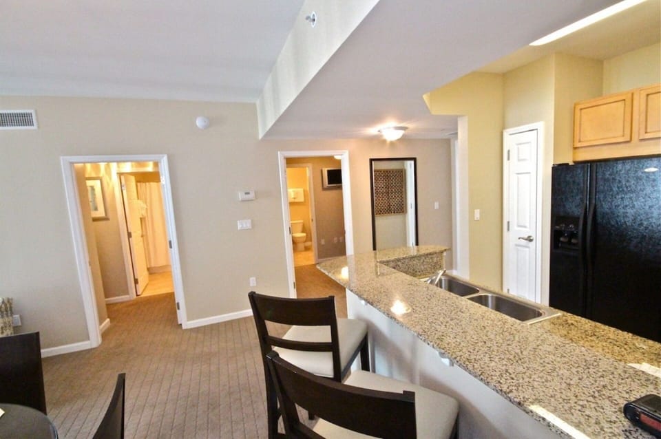 Breakfast bar with granite looking towards bedrooms