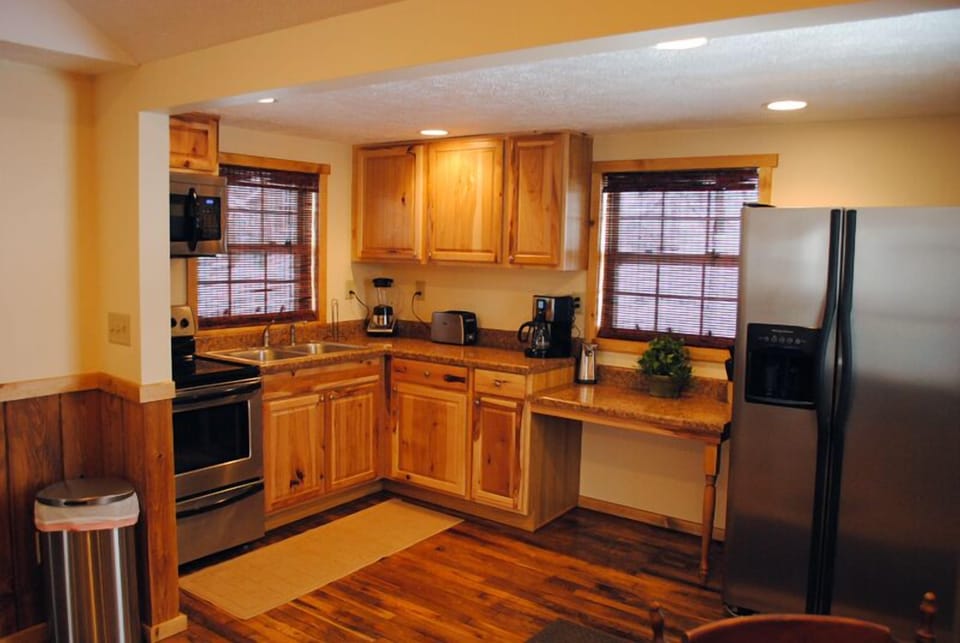 Full-stocked kitchen with modern refrigerator.