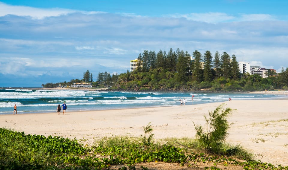 Beach nearby, white sand, beach towels, surfing